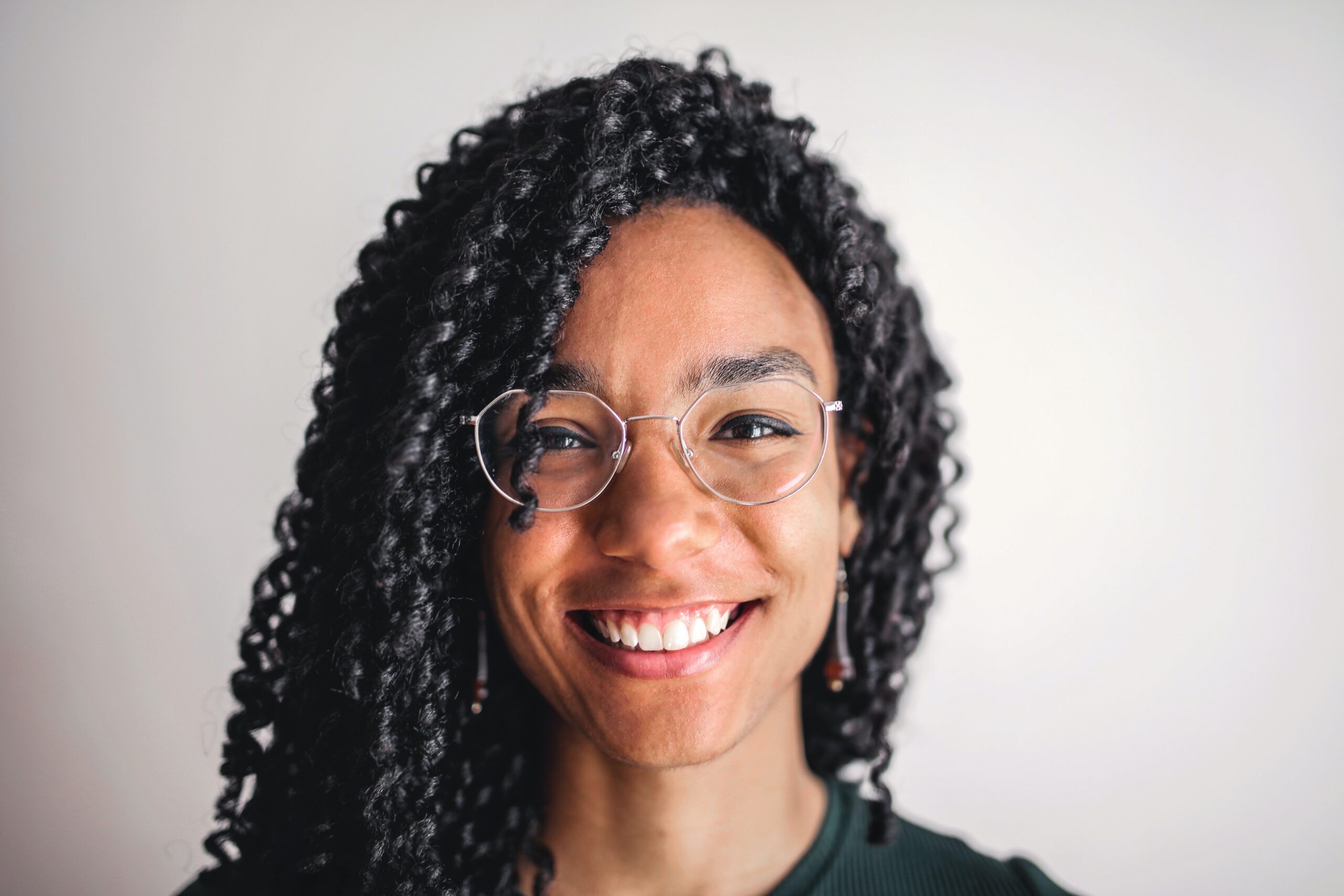 Beautiful black woman smiling, wearing eye glasses