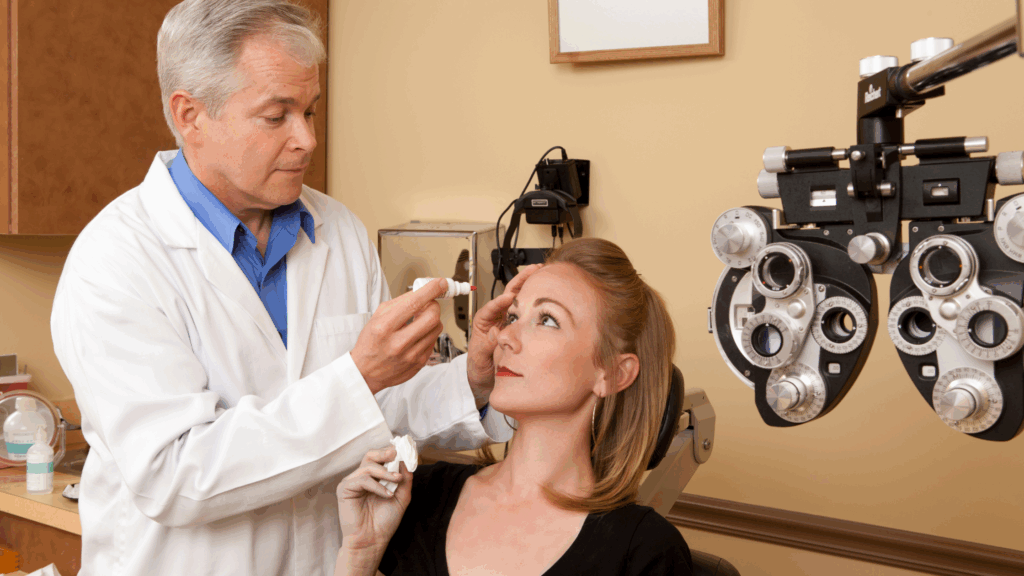 eye doctor giving eye drops to patient